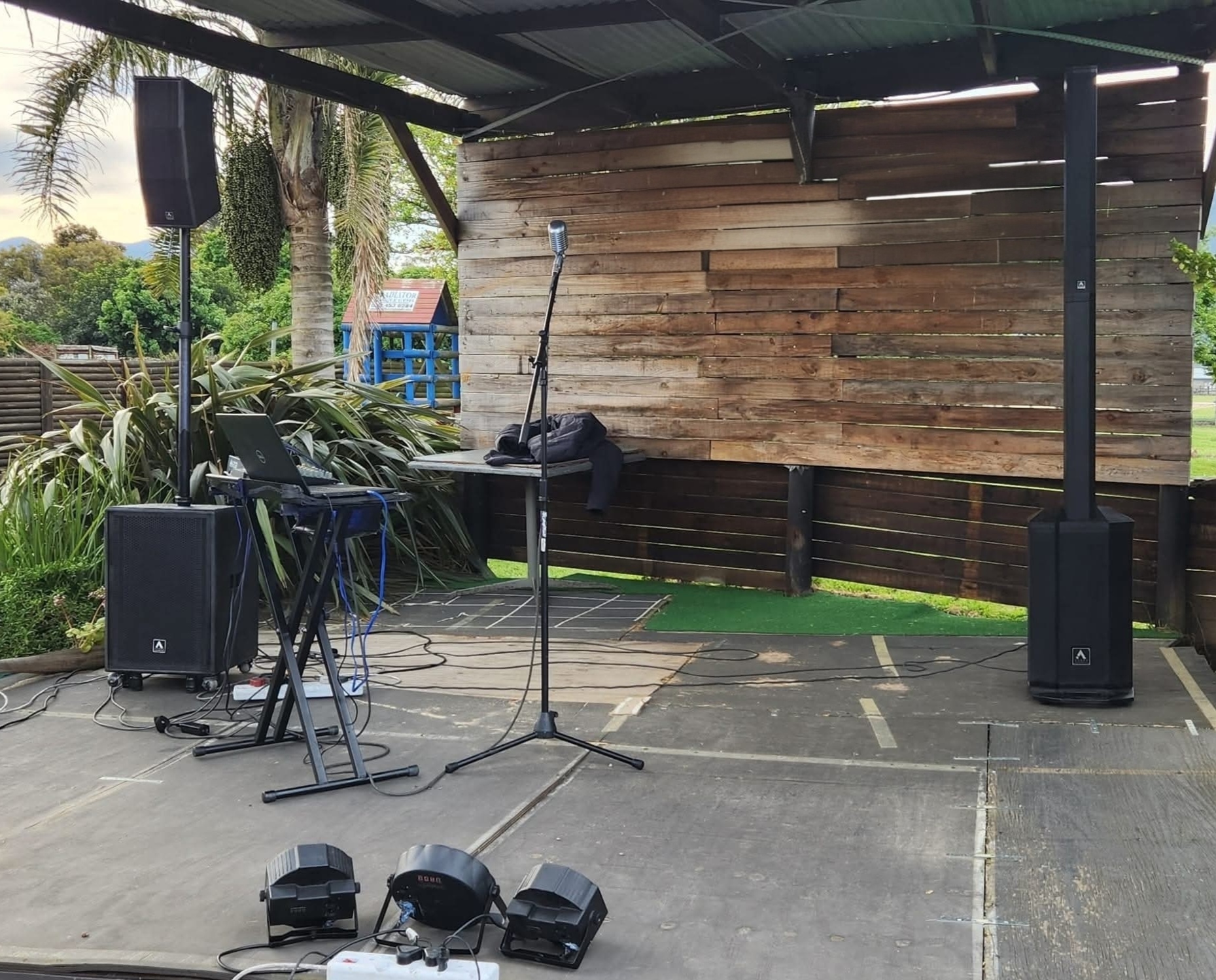 Outdoor wooden stage with Murphy sound system and microphone setup