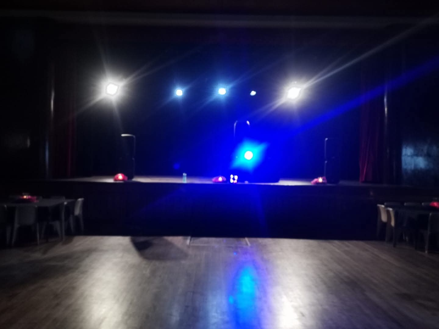 Stage lighting in a dark hall before a performance begins