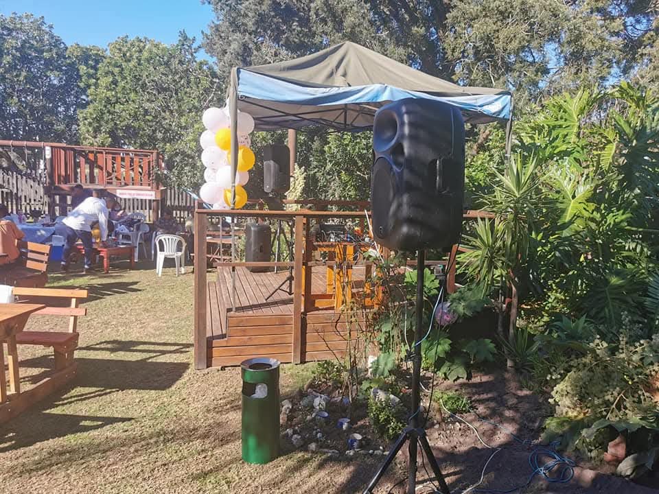 Garden event with speaker setup near an outdoor deck
