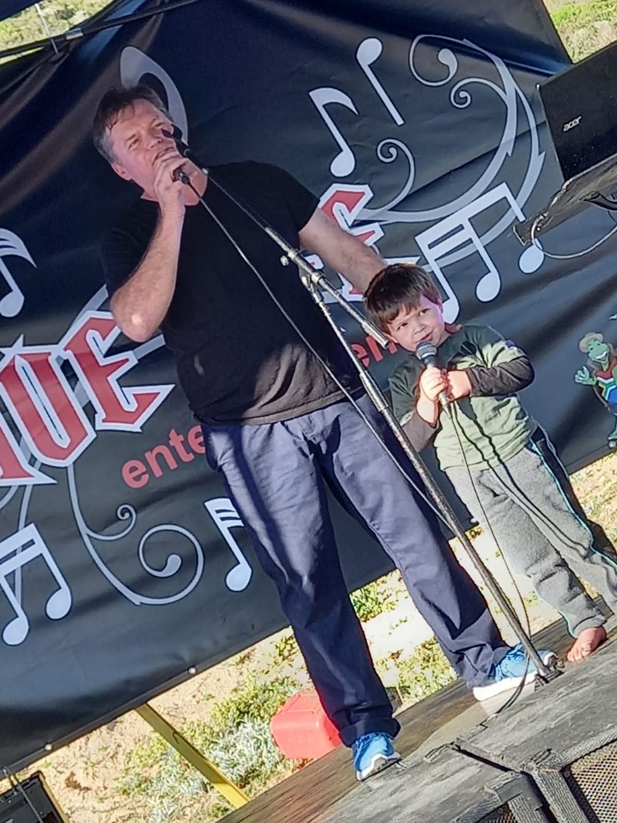 Murphy singing on stage during a family-friendly public event