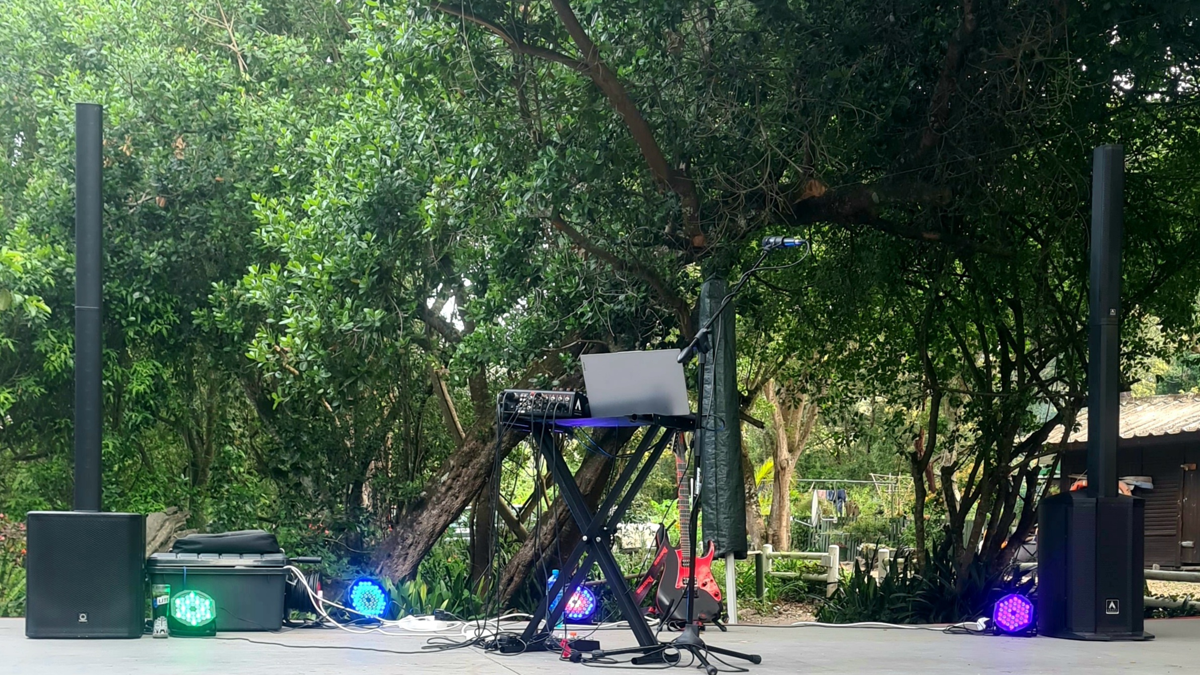 Murphy corporate garden event setup with speakers, lighting, microphone, and workstation